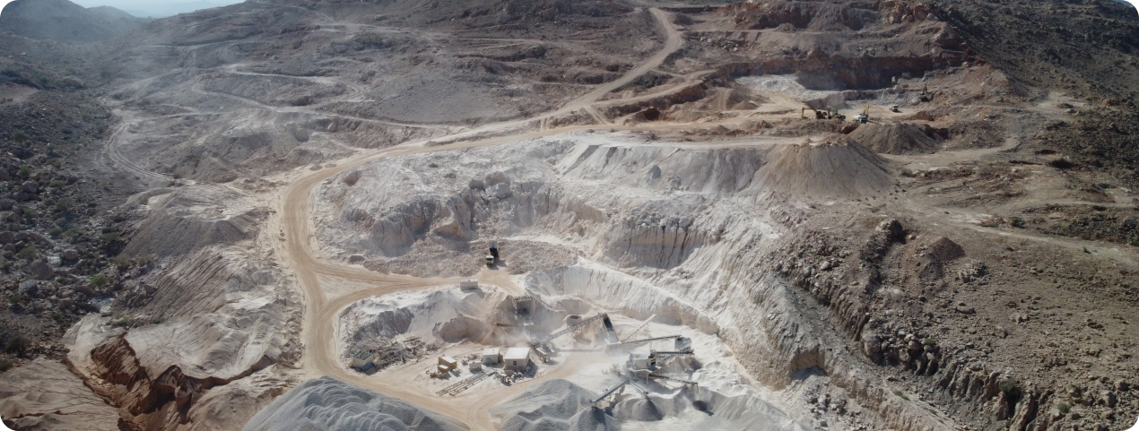 Aerial view of a large limestone quarry with various excavation levels and machinery